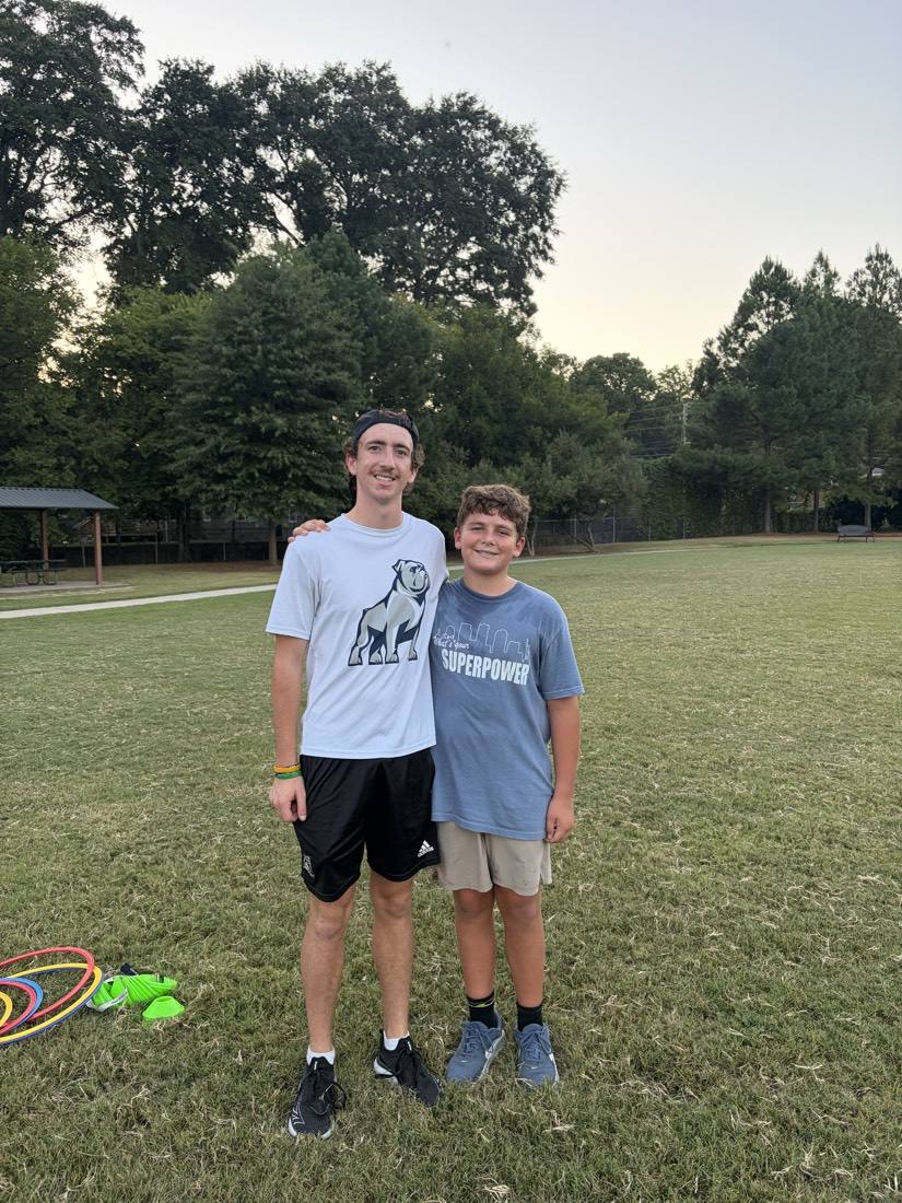 A 55 Athletics coach and a young athlete during speed and agility training